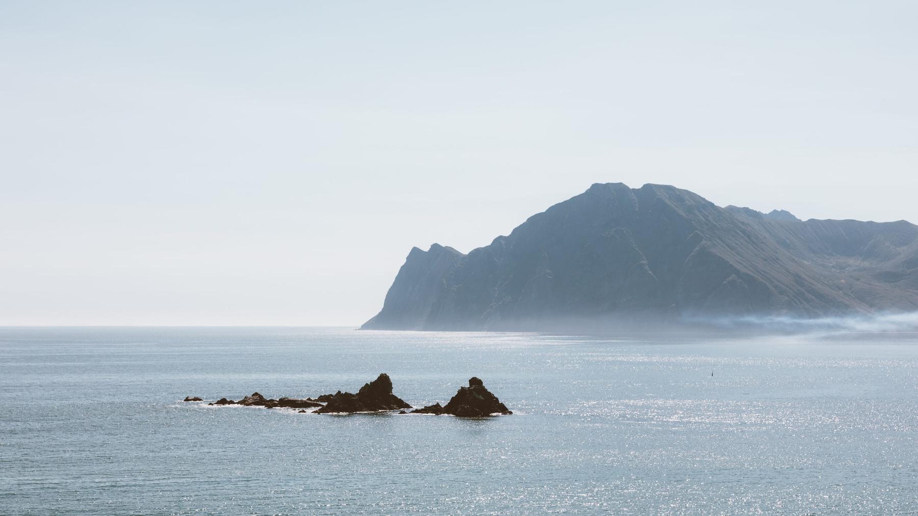 A headland above a calm sea in soft morning light